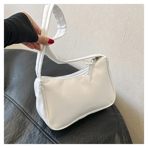 Detailed side view of a white minimalist PU leather underarm bag with zipper closure