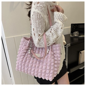 Detail of pink bubble texture tote bag featuring silver chain and large pearl charm decoration