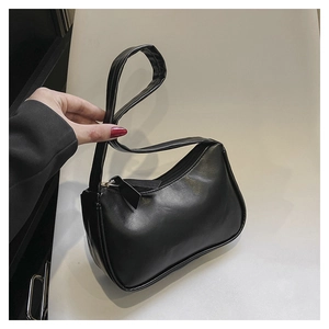 Detailed view of the black PU leather shoulder bag with smooth finish and neat stitching