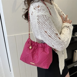 Fashionable magenta quilted crossbody bag with golden chain strap for modern women