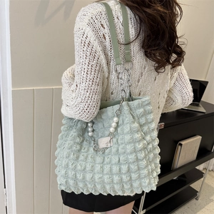 Minimalist light green puffy tote bag with pearl chain strap and metal floral charm