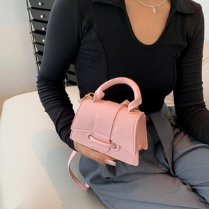 Pink hourglass mini handbag with lychee pattern on a model for a stylish crossbody look