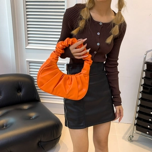 Fashionable bright orange pleated crescent handbag with a textured cloud-like PU leather finish