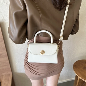 Minimalist white square shoulder bag in glossy PU leather with gold clasp on model