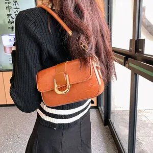 Brown crocodile embossed minimalist baguette bag with large gold buckle and chain strap