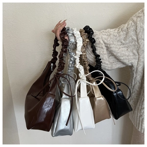Detail of five assorted scrunchie shoulder bags with elegant ribbon bow accents
