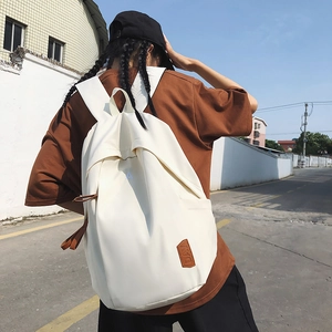 Minimalist beige casual backpack for students featuring a waterproof day-pack design
