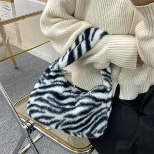 Plush tote bag in classic black and white zebra print with retro half-moon design