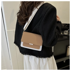 Rear view of model wearing a minimalist khaki and white crossbody bag with wide strap