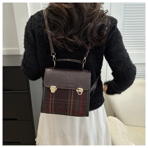 Rear view of a model wearing a vintage plaid patchwork backpack with metal buckles