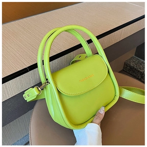 Detail of fruit green mini handbag with gold metal buckles and fashion text logo