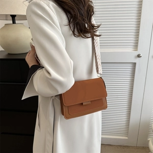 Minimalist caramel brown rectangle shoulder bag with wide woven patterned strap