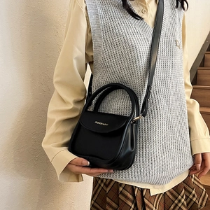Classic black PU leather crossbody handbag with top handle for women in a minimalist style