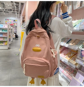 Detailed view of pink corduroy backpack with cute 3D duck face and yellow bill feature