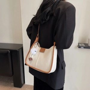 Minimalist off-white leather shoulder bag for women with plush ball and large capacity