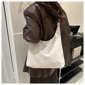 Minimalist white PU leather Hobo bag shown with a dark brown blazer for city commute