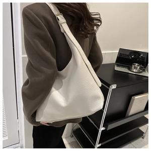 Close-up of cream lychee texture leather hobo bag with adjustable shoulder strap
