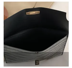 Detail of the black crocodile pattern envelope clutch showing its spacious inner compartment