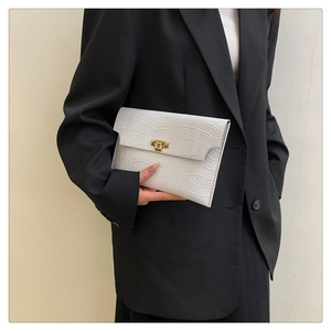 Detailed view of white crocodile pattern envelope clutch with a gold rectangular metal lock
