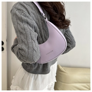 Chic light purple half-moon underarm bag with fashion text shown on casual outfit