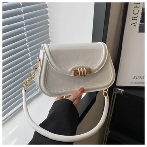 Detail of white minimalist handbag with gold triple-ring lock and leather texture
