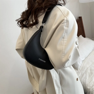 Minimalist black crescent shoulder bag with white fashion lettering and matte leather finish