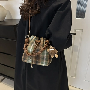 Minimalist wool bucket bag with green plaid pattern and braided handle for women
