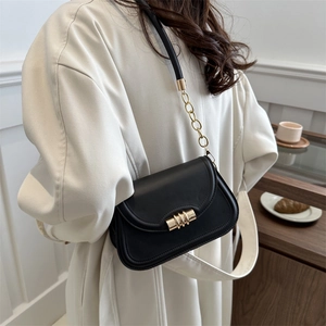 Fashionable black matte leather crossbody square bag with gold metal lock worn by a model