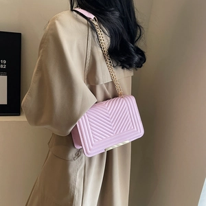 Chic mauve V-quilted chain shoulder bag for women shown as a stylish crossbody on a model