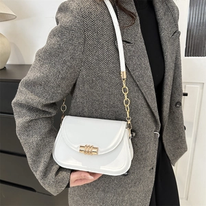 Chic white leather shoulder bag with gold metal buckle and chain strap for women