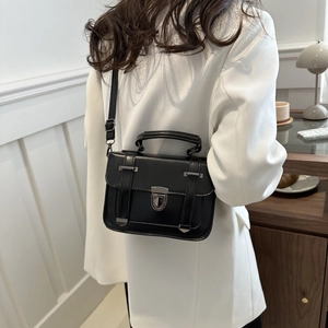 Vue arrière d'un sac bandoulière rétro noir avec fermoir métallique et bandoulière