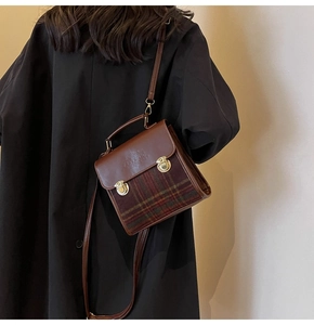 British style checkered crossbody bag detail with metallic buckle and leather handle