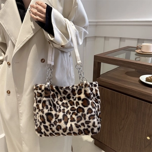 Chic leopard print plush tote bag with chain strap styled on a cream coat outfit