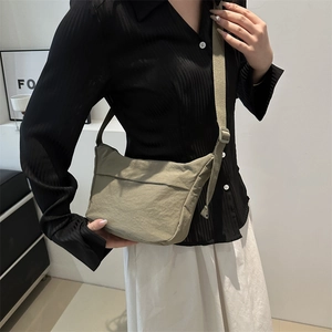 Minimalist khaki green nylon tote bag with adjustable wide shoulder strap for casual wear
