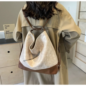 Detail showing the contrast leather straps and silver zipper on this large tote bag