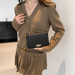 Classic black quilted chain crossbody bag with gold hardware and flap turn-lock closure