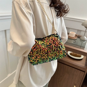 Colorful sequin mini crossbody bag with gold chain strap shown on a casual female model