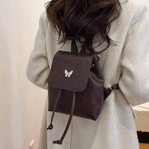 Minimalist vintage dark brown leather backpack with white butterfly accent for women