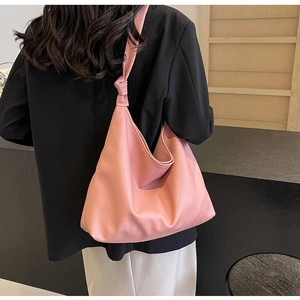Detail view of pink large capacity tote bag featuring stylish shoulder strap knot design