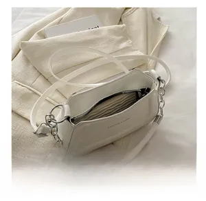 Detailed interior view of the white crossbody bag showing storage space and zipper closure