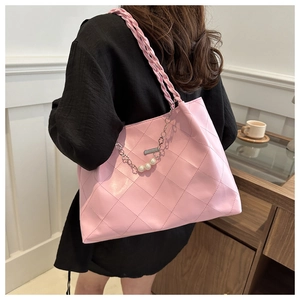 Pink quilted leather tote bag detail featuring woven straps and elegant pearl chain
