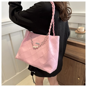 Pink quilted tote bag detail with braided shoulder strap and pearl chain decoration