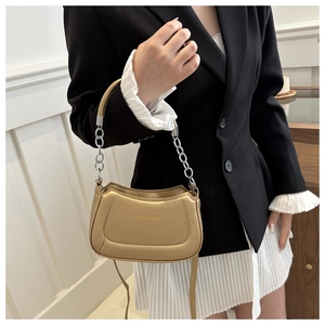 Detail view of champagne gold Hobo bag with metal chain strap and leather handle