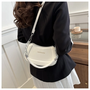 Close-up of white PU leather dumpling bag with silver chain strap and fashion text
