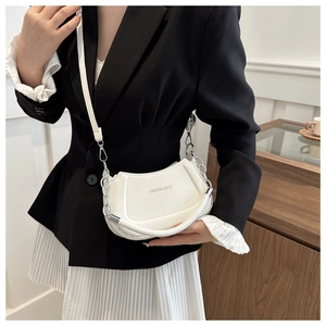 Close-up of a white minimalist dumpling bag with FASHION & BAGS gold text and chain