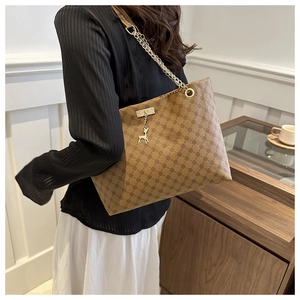 Brown vintage tote bag featuring geometric floral patterns and a gold chain shoulder strap