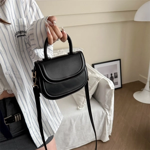 Classic black vintage saddle bag with gold hardware and top handle for women