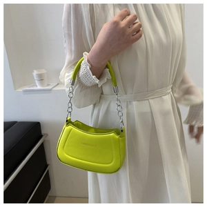 Fashionable neon green crossbody bag featuring silver chain strap and top handle
