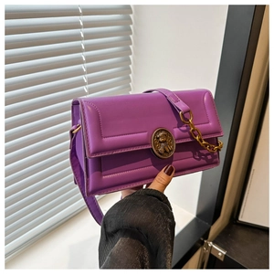 Detail of purple crossbody bag featuring a retro bronze bear relief metal buckle and chain