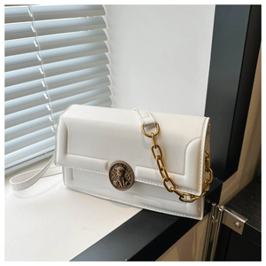 Detail of white PU leather square bag with gold chunky chain and vintage crest buckle